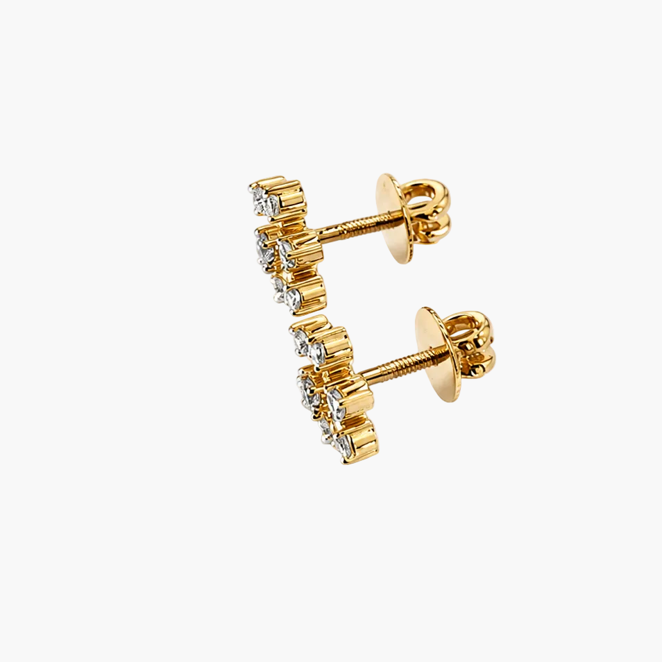 Gold earrings with clear gemstones on a white background