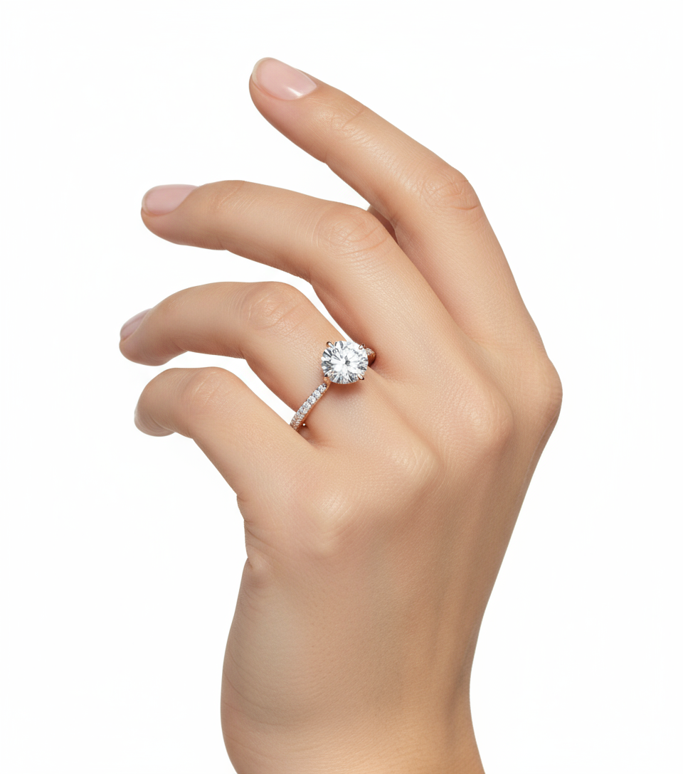 Female model wearing delicate rose gold solitaire diamond ring