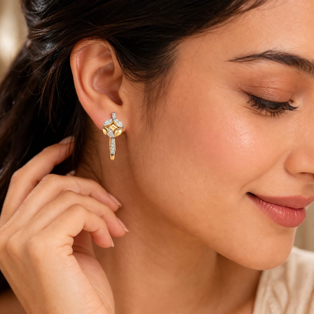 Close-up of a woman wearing gold earrings with a neutral background