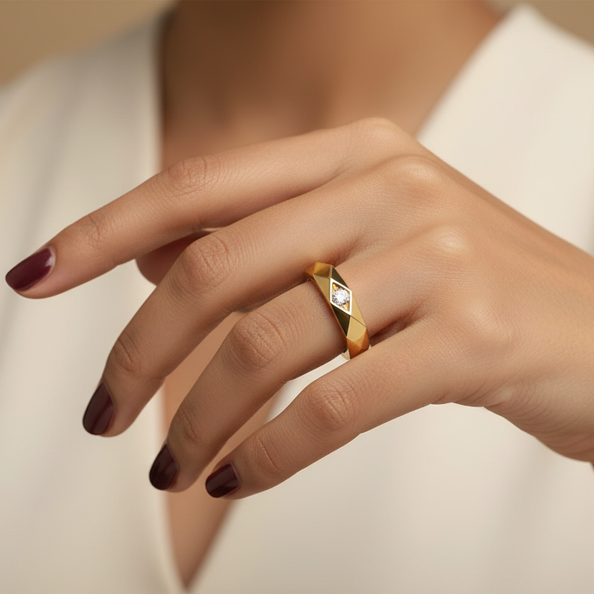 Generated image of an Indian female model wearing the yellow gold faceted geometric band ring with all-over diamond-cut faceted exterior and single flush-set round brilliant diamond accent