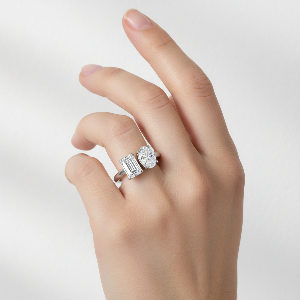 White gold two-stone ring with emerald-cut and oval diamond on model