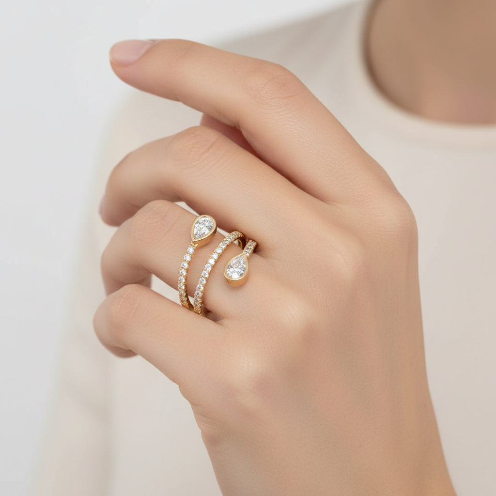 Yellow gold bypass ring with pear diamonds on model