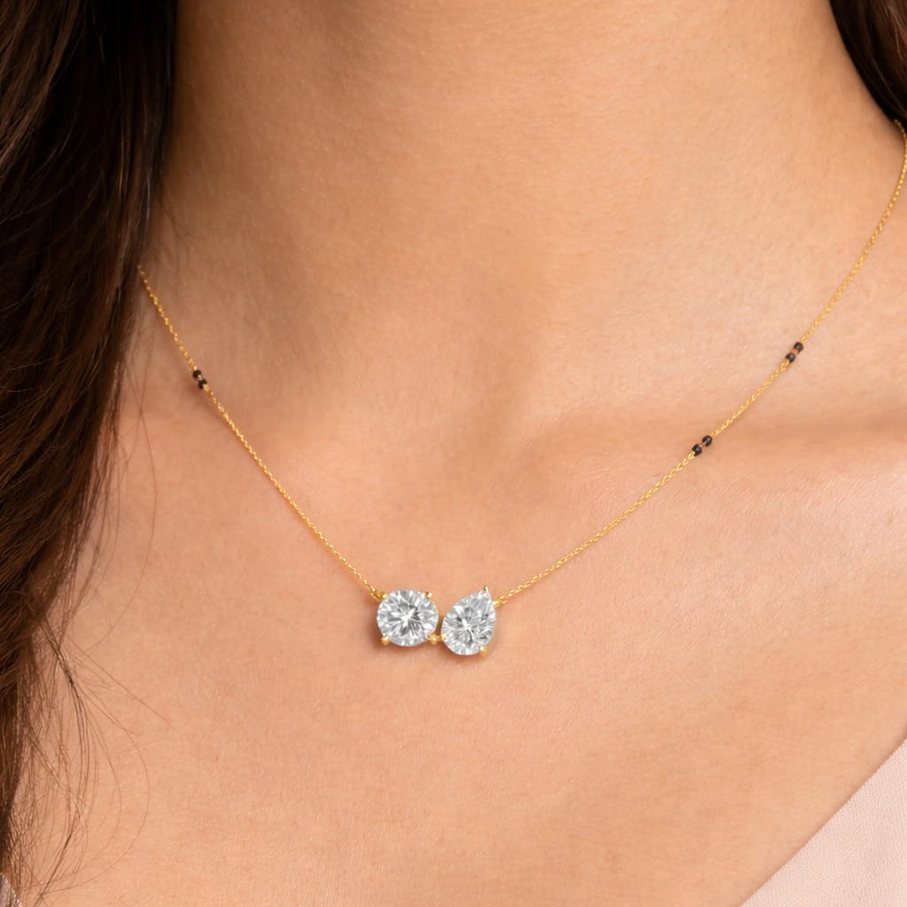Necklace with two blue gemstones worn by a person