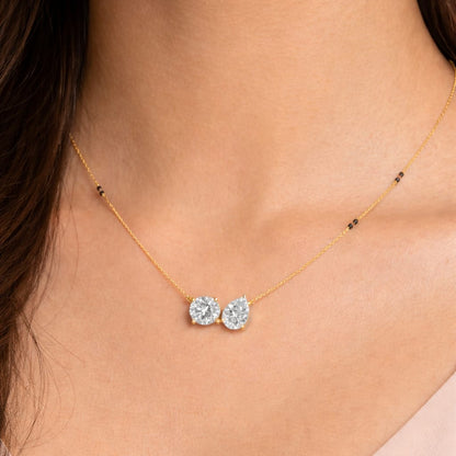 Necklace with two blue gemstones worn by a person