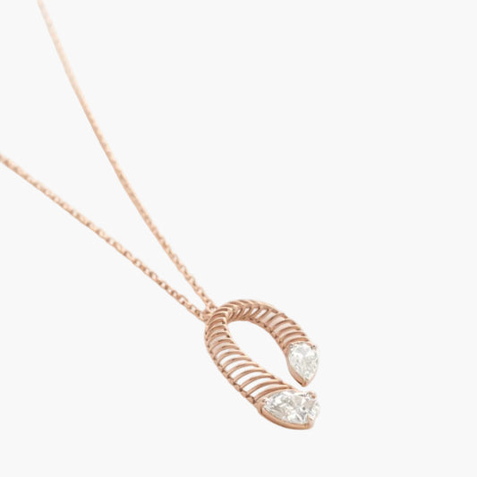 Rose gold necklace with a unique pendant on a white background