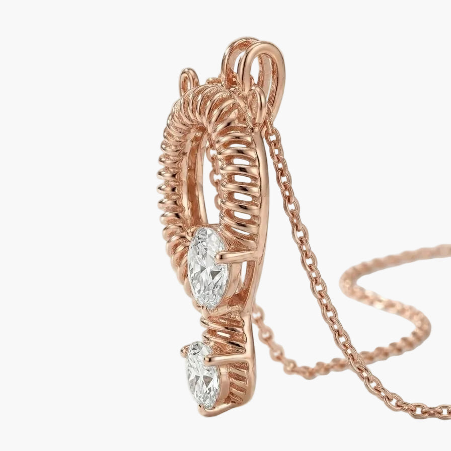 Rose gold earring with heart-shaped gemstones on a white background