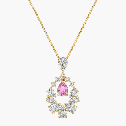 Gold necklace with a pink gemstone pendant on a white background