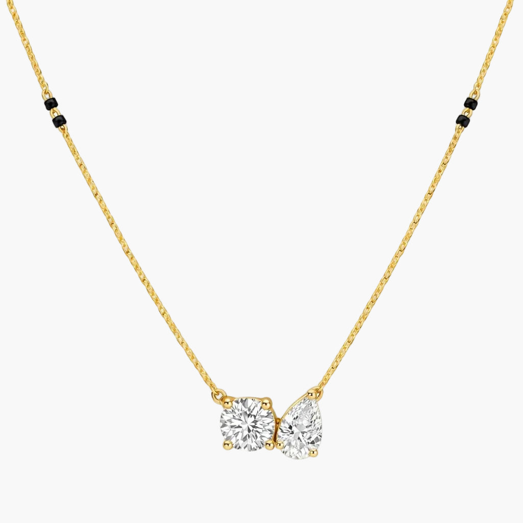 Gold necklace with a diamond pendant on a white background