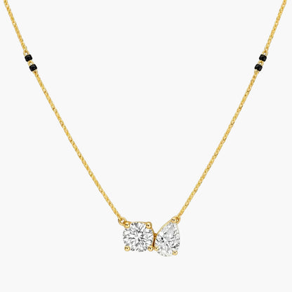 Gold necklace with a diamond pendant on a white background