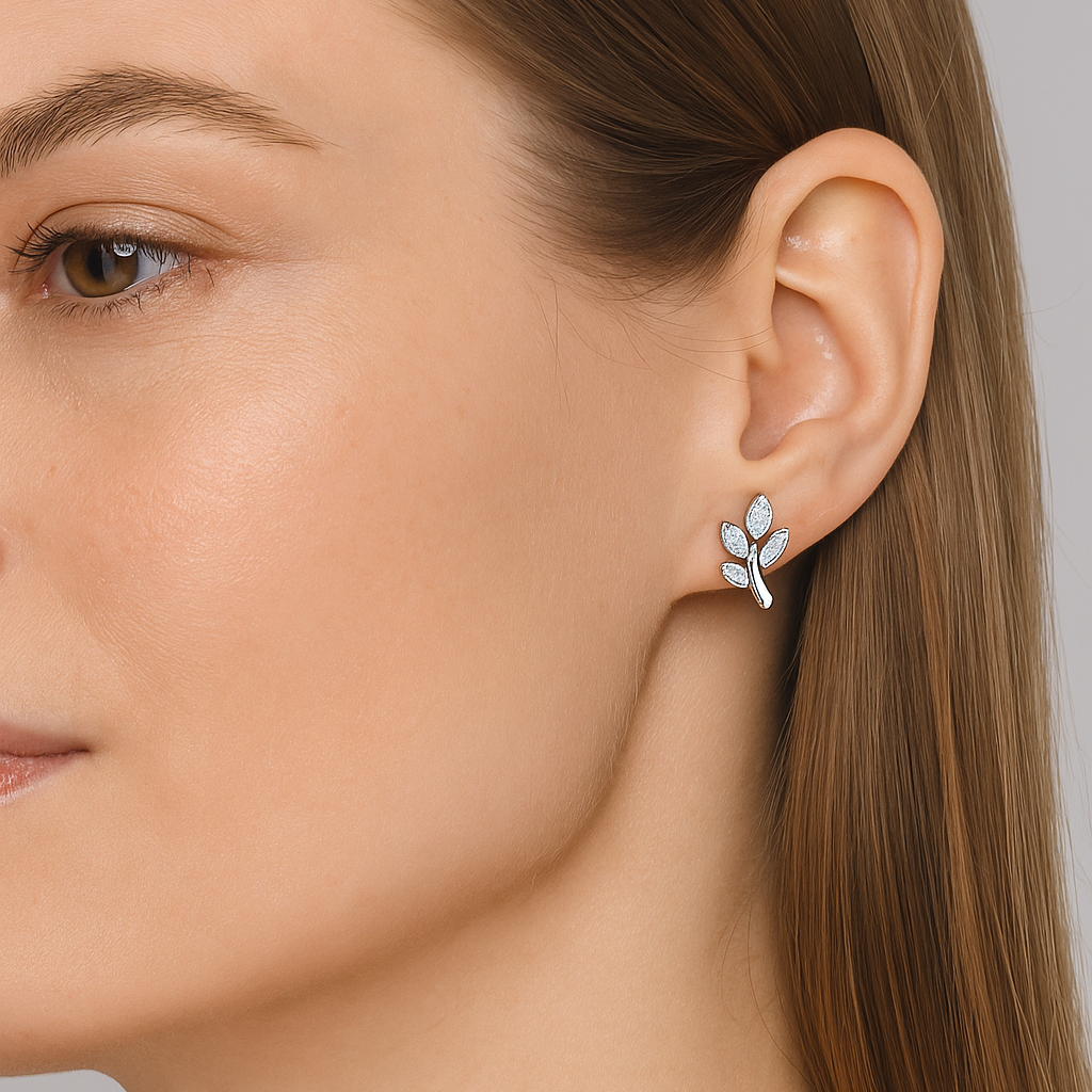 Close-up of a woman wearing a silver earring with a gray background