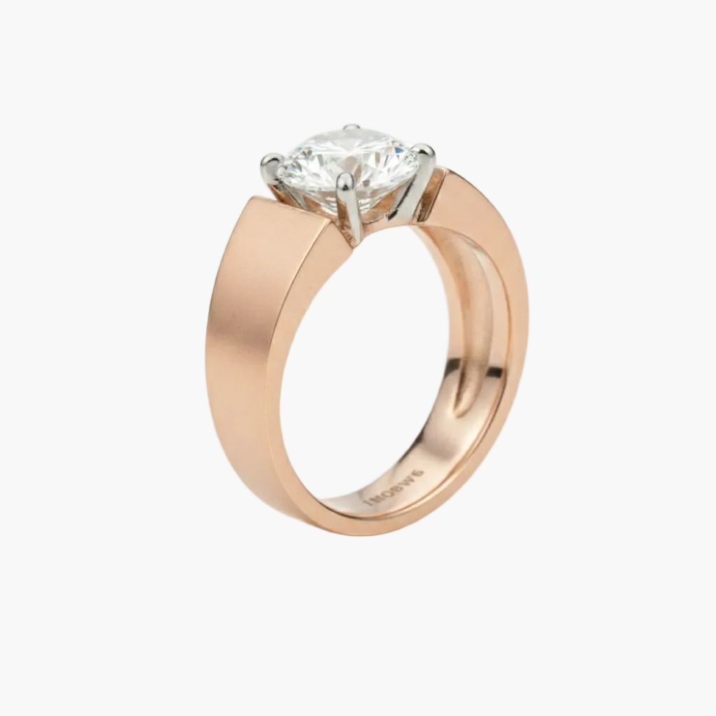 Rose gold ring with a diamond on a light gray background