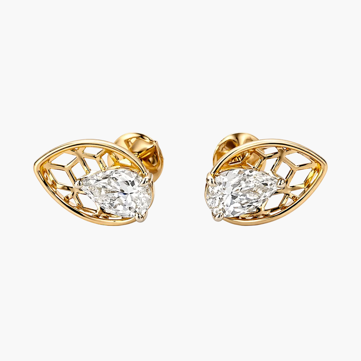 Gold earrings with diamond-like stones on a white background