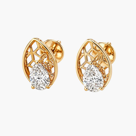 Gold earrings with diamond-like stones on a white background