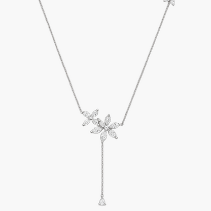 Silver necklace with floral pendants on a white background