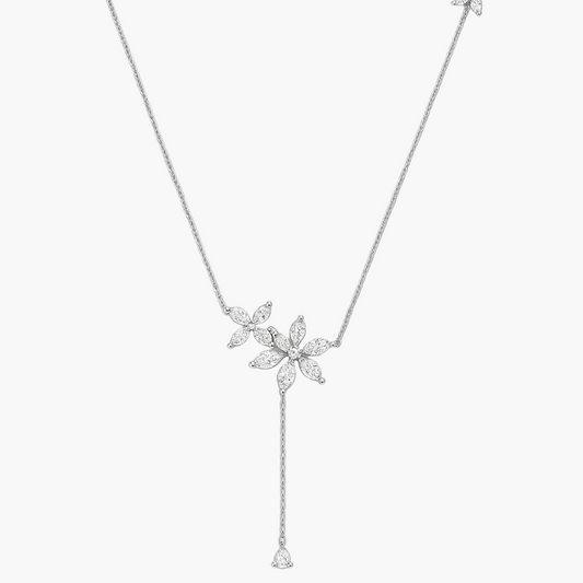 Silver necklace with floral pendants on a white background
