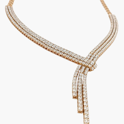 Rose gold necklace with diamonds on a white background