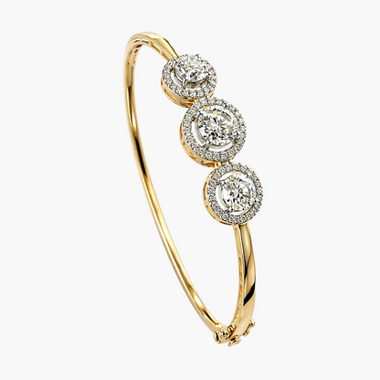 Gold bracelet with three diamond-like stone settings on a white background