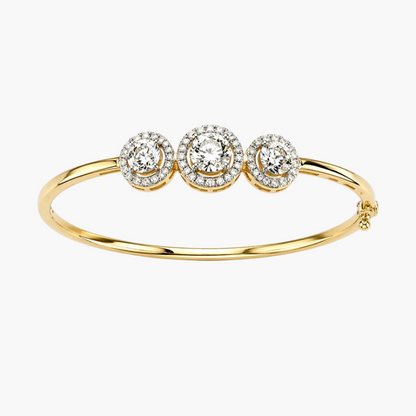 Gold bracelet with three round diamond-like stones on a white background