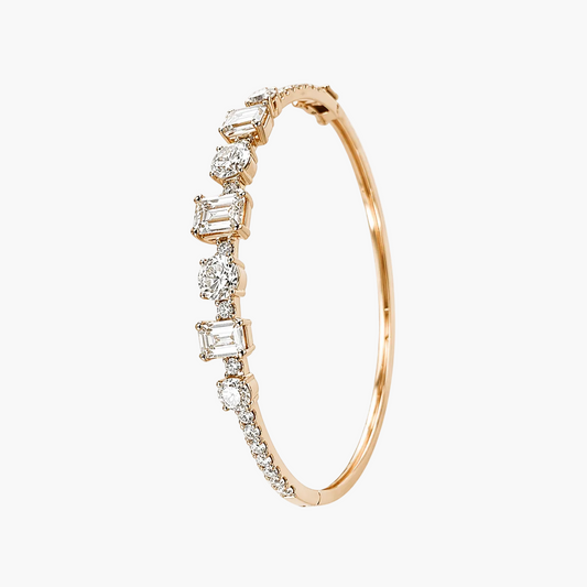 Rose gold bracelet with diamond accents on a white background