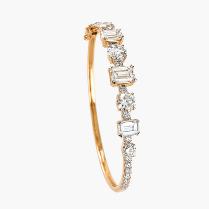 Gold bracelet with diamond accents on a white background