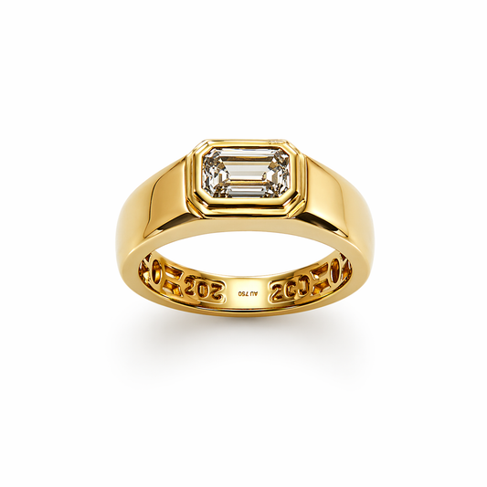 Gold ring with emerald-cut diamond on a white background