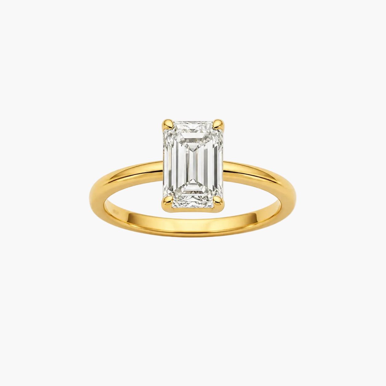 Gold ring with a rectangular diamond on a white background