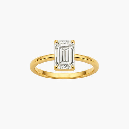 Gold ring with a rectangular diamond on a white background