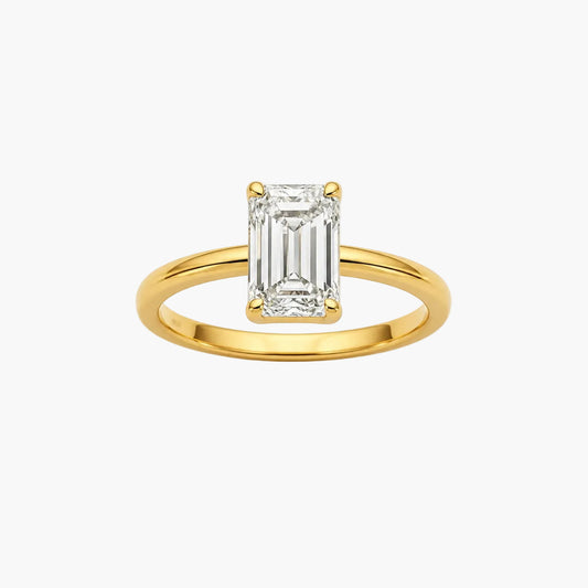 Gold ring with a rectangular diamond on a white background