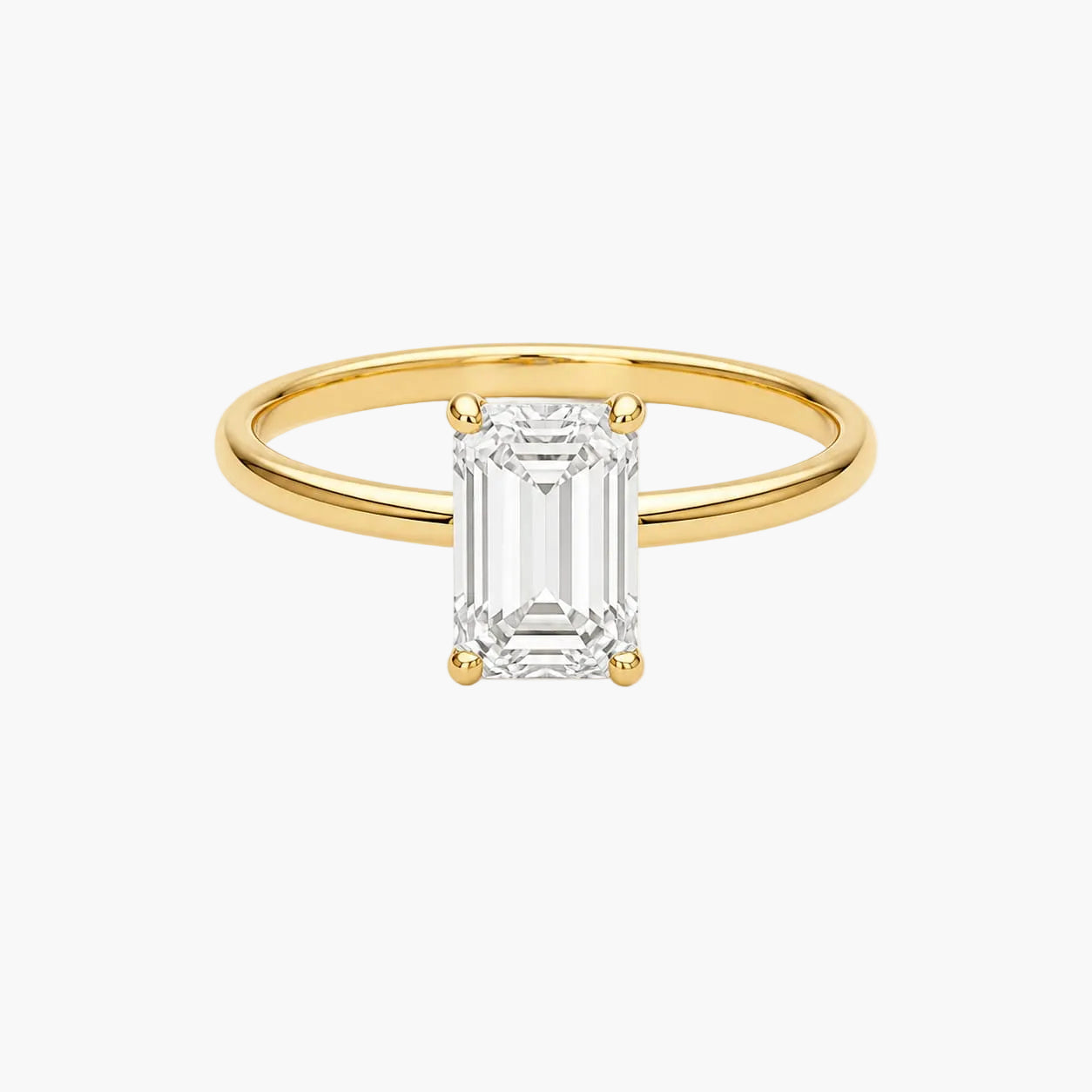 Gold ring with a rectangular diamond on a white background