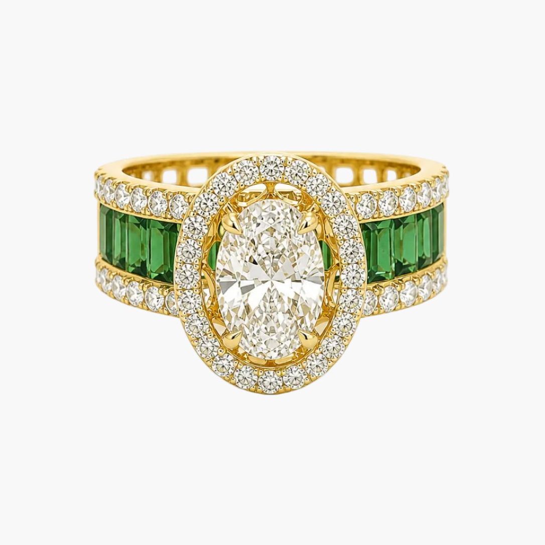 Gold ring with central diamond and emerald stones on a white background