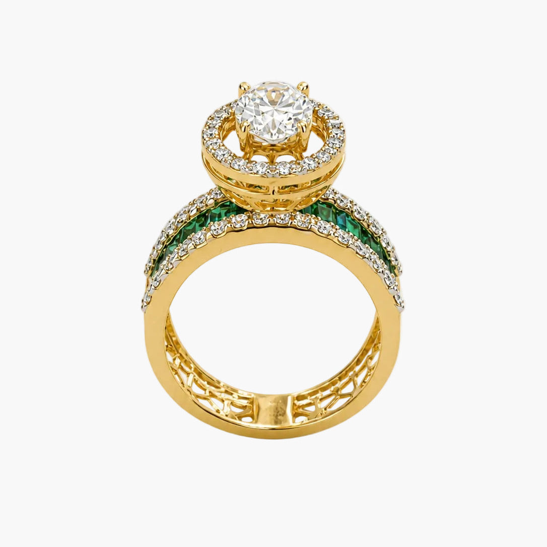 Gold ring with diamond and emerald accents on a white background