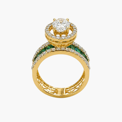 Gold ring with diamond and emerald accents on a white background