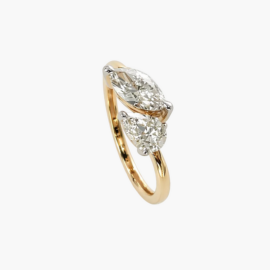 Gold ring with diamond accents on a white background