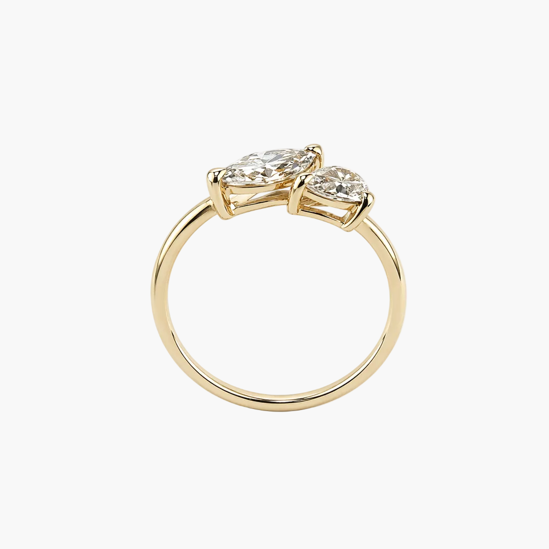 Gold ring with two diamonds on a white background
