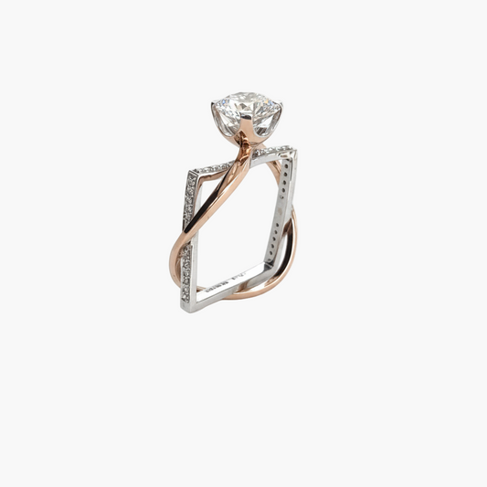 Rose gold and silver ring with a diamond on a white background