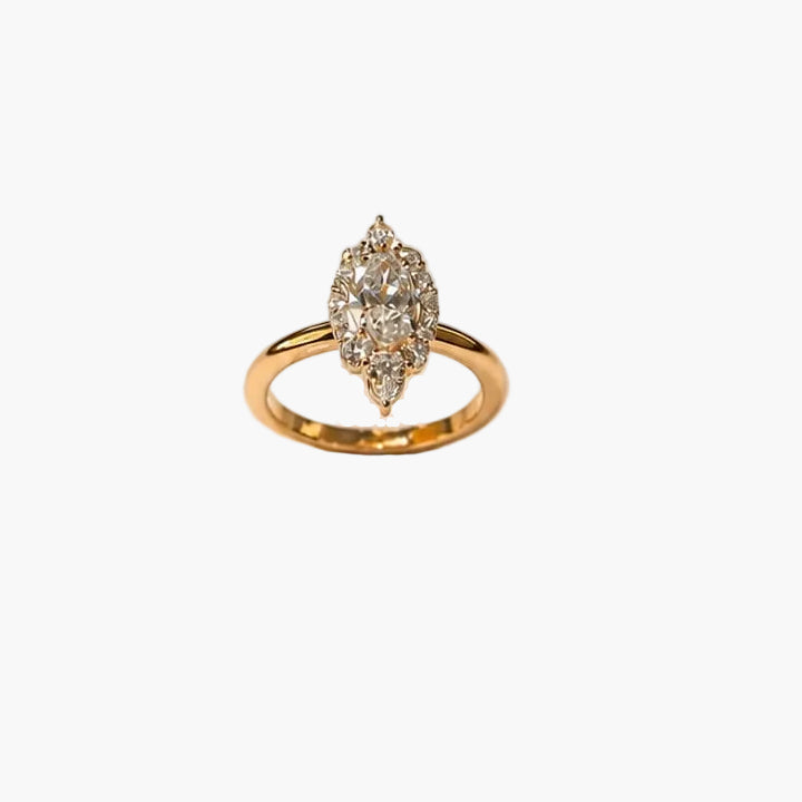 Gold ring with a diamond on a light beige background