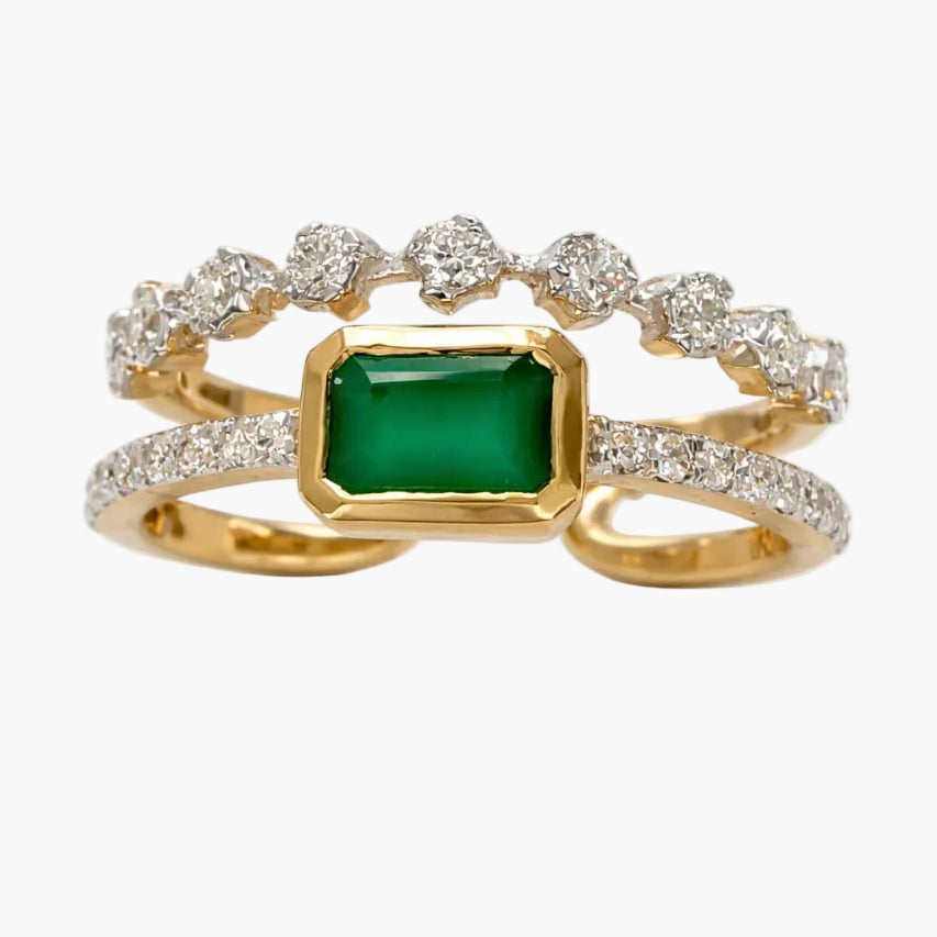 Gold ring with a green gemstone and diamond accents on a white background
