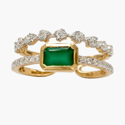 Gold ring with a green gemstone and diamond accents on a white background
