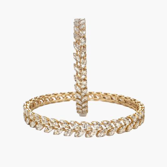 Gold hoop earrings with diamond accents on a white background