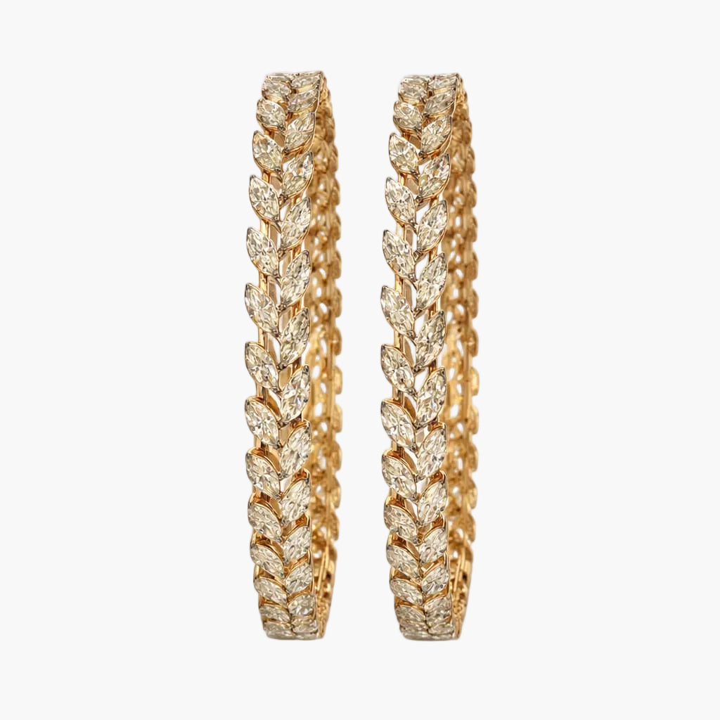Pair of gold earrings with intricate design on a white background