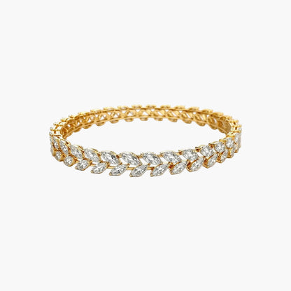 Gold bracelet with diamond accents on a white background