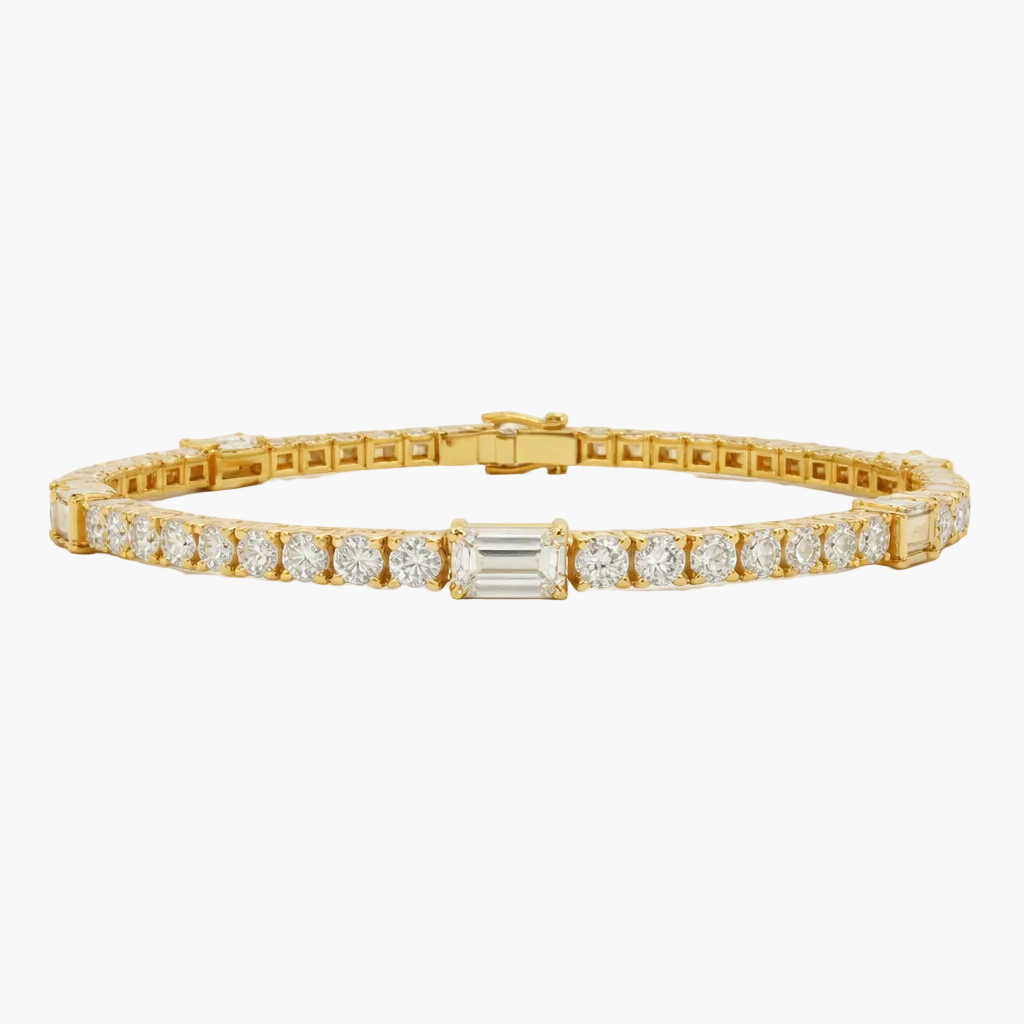 Gold bracelet with diamond accents on a light gray background