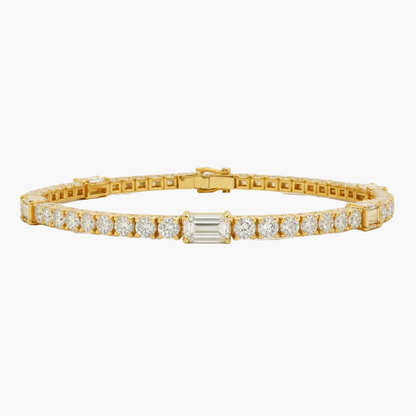 Gold bracelet with diamond accents on a light gray background