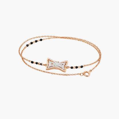 Rose gold bracelet with star-shaped clasp and black beads on a white background