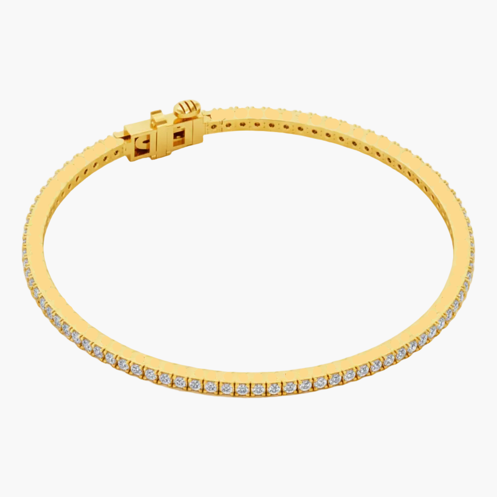 Gold bracelet with embedded stones on a white background