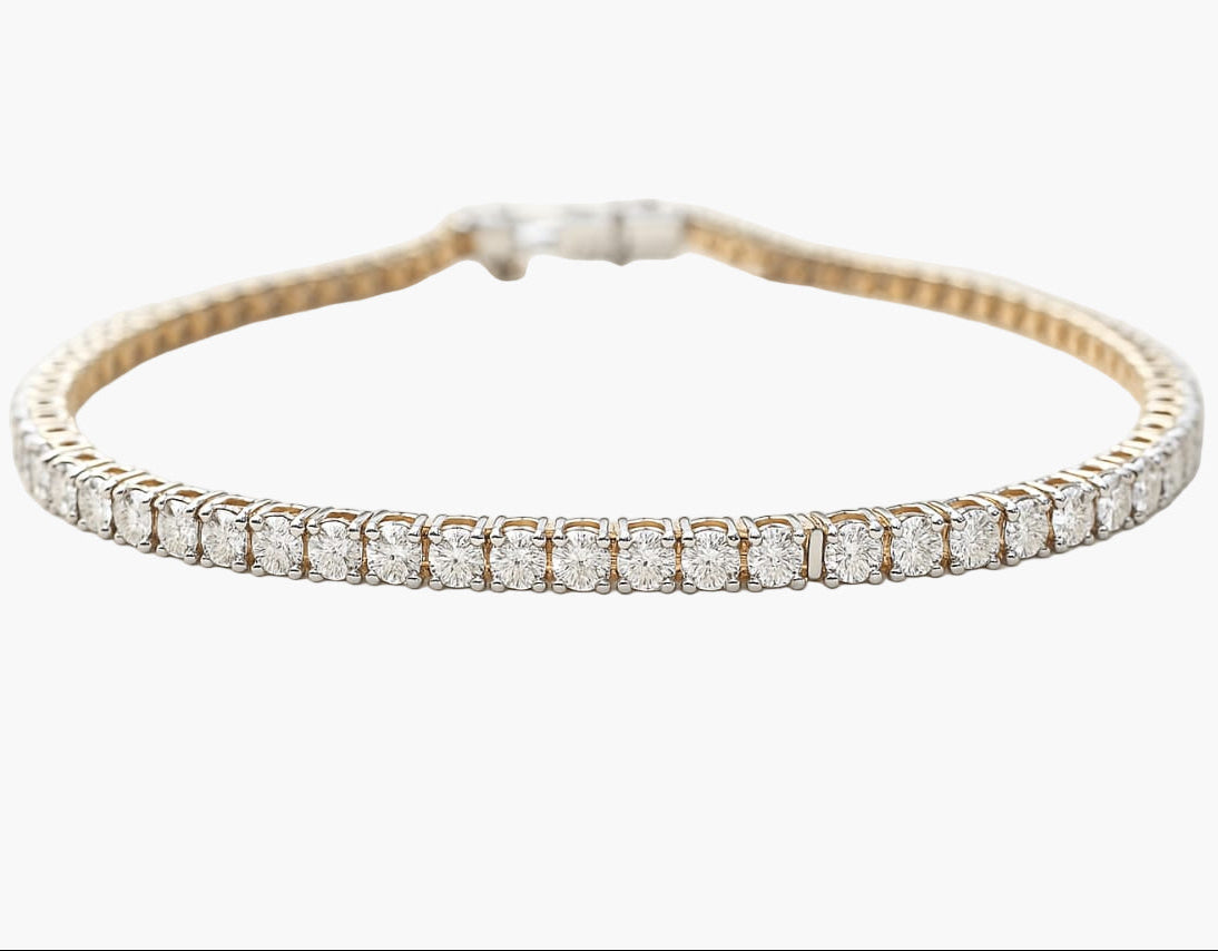 Gold bracelet with diamonds on a white background