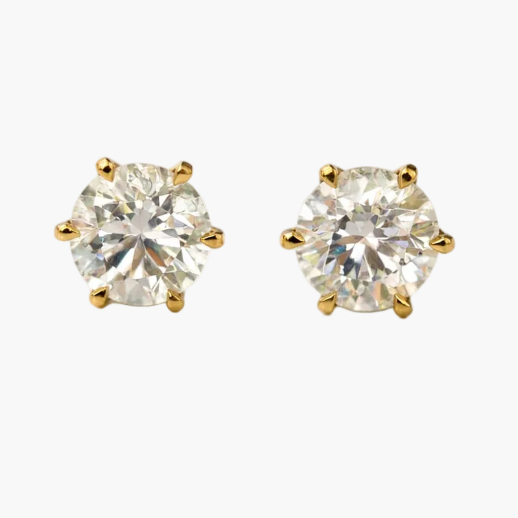 Pair of diamond stud earrings on a white background