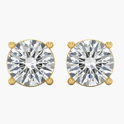 Gold earrings with large clear gemstones on a white background