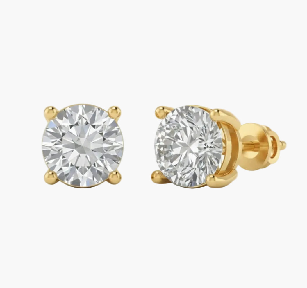 Gold stud earrings with clear gemstones on a white background