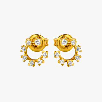 Gold earrings with diamond accents on a white background